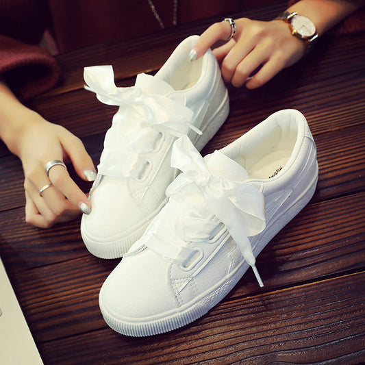 White tennis shoes with ribbon